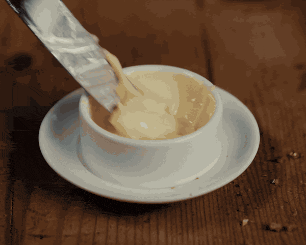 Quick cuts of a child's school morning in Baby Dior's back to school film: toast, cereal, a sleepy breakfast table in soft window light