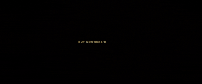 A cyclist riding through a concrete underpass, after an opening title card on black