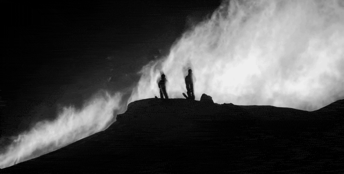 Black and white: two skiers silhouetted on a ridge as powder blows across the frame in Salomon's Sentry Pro film