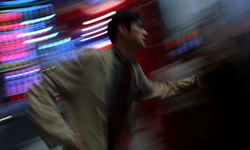 A man running through smeared neon light, the step-printed motion blur from Chungking Express