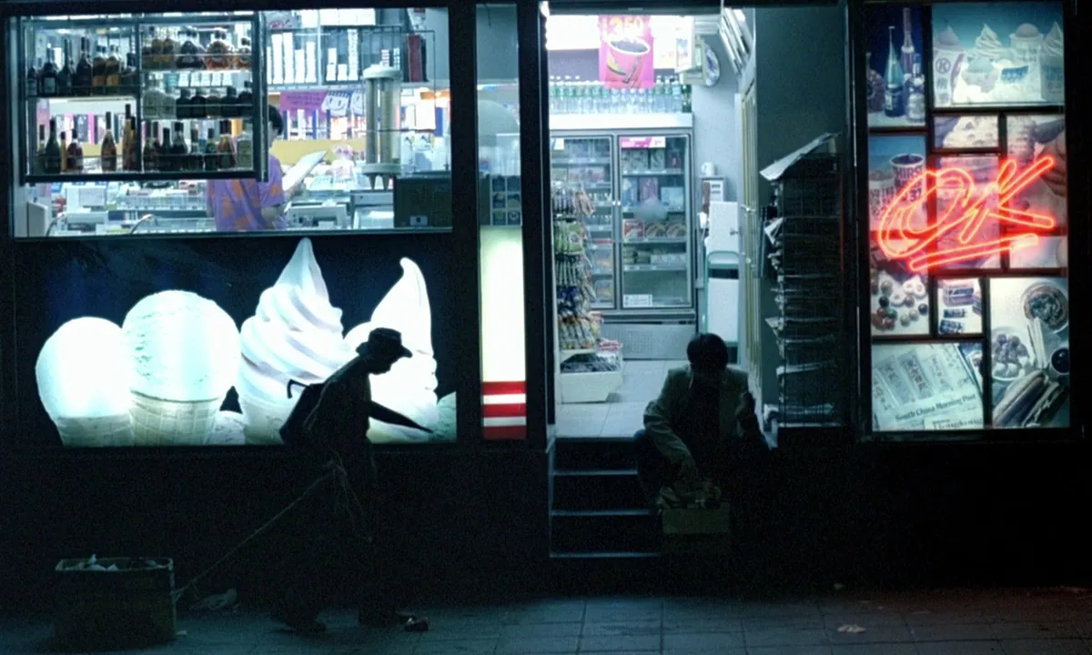 A shopfront at night lit only by its own glowing signs