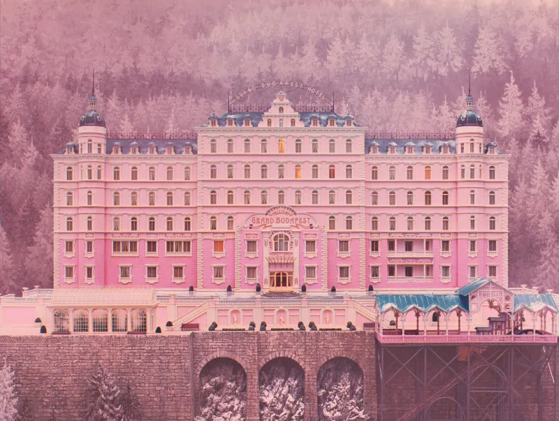 The pink Grand Budapest Hotel facade, dead centre under a snowy mountain