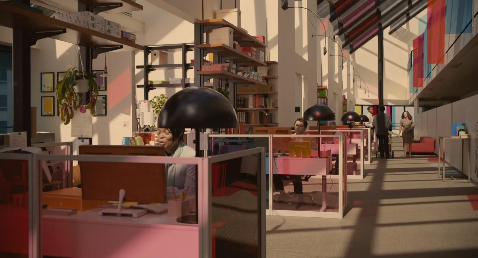 A soft pastel open-plan office with rows of desks, from Her
