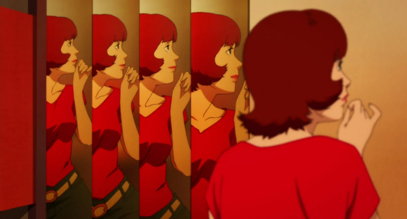 A red-haired girl in red reflected again and again through a row of mirrored panels