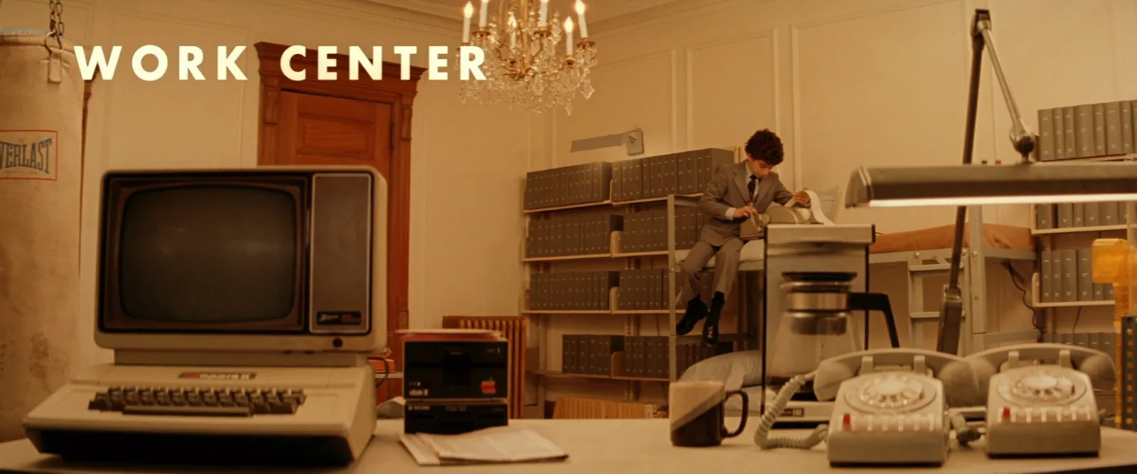 A retro office desk labelled WORK CENTER, with a typewriter and beige office equipment laid out like a museum exhibit