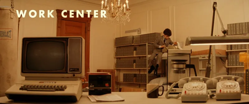 A retro office desk labelled WORK CENTER, with a typewriter and beige office equipment laid out like a museum exhibit